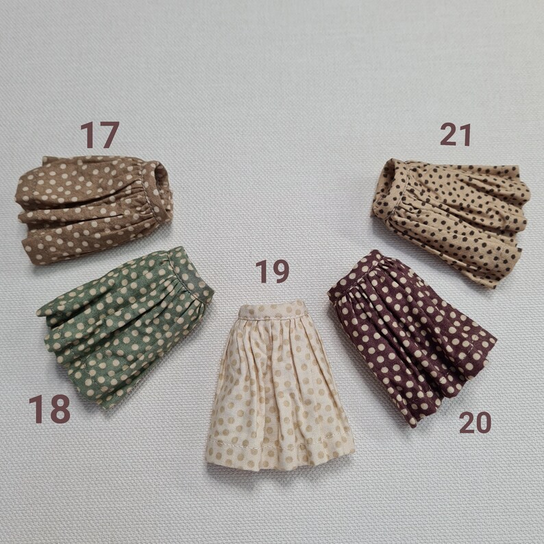 May include: Five different polka dot skirts in various colors and patterns. The skirts are numbered 17, 18, 19, 20, and 21.