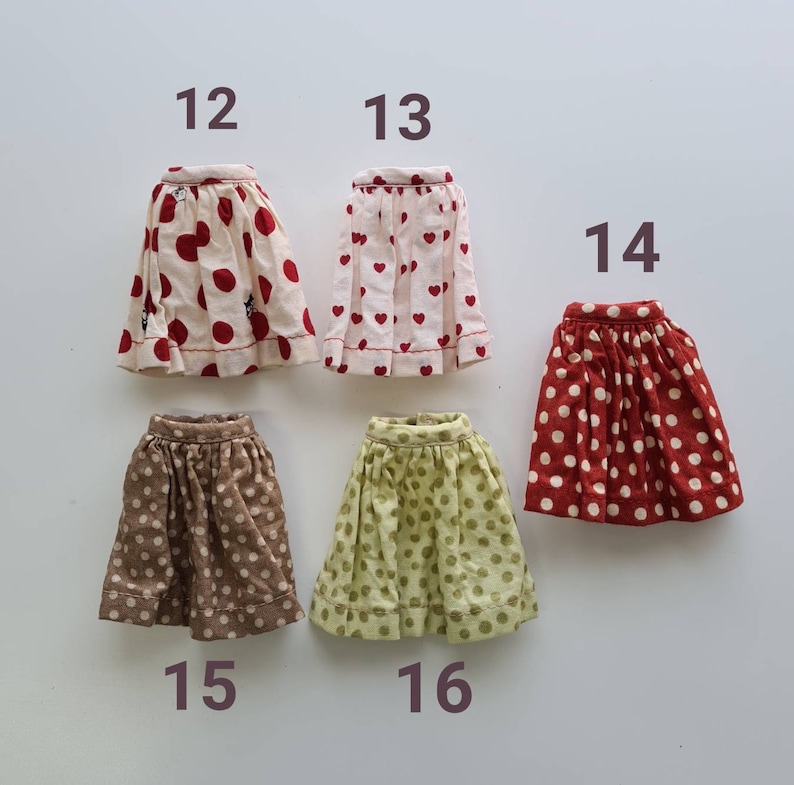 May include: Six different polka dot skirts in various colors and patterns. The skirts are numbered 12 through 16.