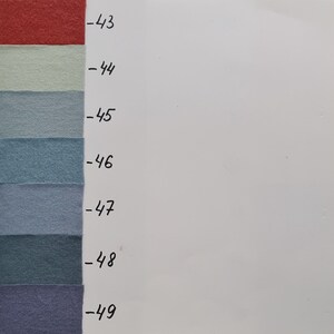 May include: A vertical colour chart featuring seven rectangular fabric swatches in shades of red, light green, and various tones of blue and purple. Each swatch is labelled with a corresponding number from -43 to -49 in black handwritten text.