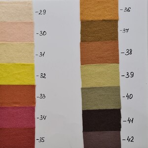 May include: A colour chart featuring fourteen rectangular fabric swatches arranged in two vertical columns. Each swatch is labelled with a number from 29 to 42, displaying a range of colours including cream, yellow, pink, red, orange, brown, and grey.