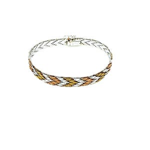 May include: A silver bracelet with a woven design featuring alternating sections of silver, gold, and rose gold. The bracelet has a secure clasp and is displayed against a white background. This piece of jewelry is suitable for everyday wear.