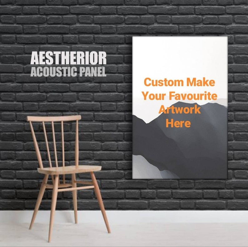 May include: A white acoustic panel with the text "AESTHEIROR ACOUSTIC PANEL" in gray and the text "Custom Make Your Favourite Artwork Here" in orange. The panel is hanging on a black brick wall with a wooden chair in front of it.