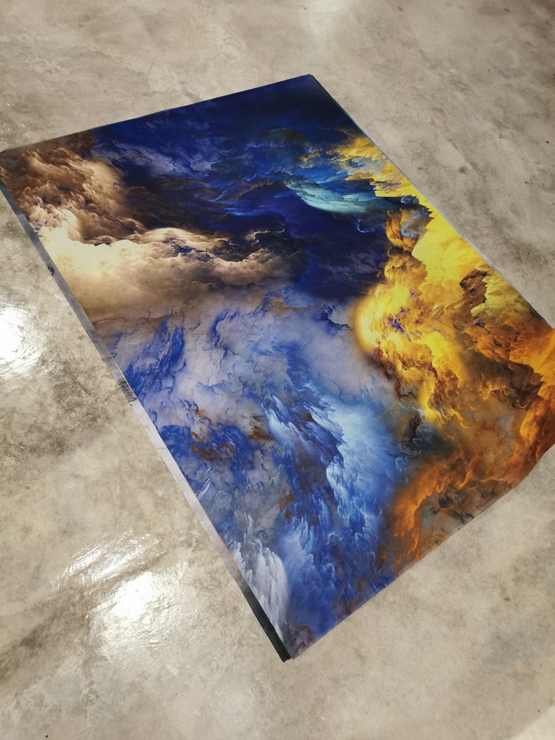May include: Abstract art print featuring a swirling mix of blue, yellow, and brown clouds. The colors blend together to create a sense of movement and depth.