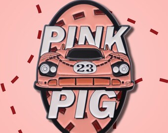 May include: A pink enamel pin featuring a race car design with the words "PINK PIG" in white block letters. The car has the number 23 on it. The pin is set against a pink background with red rectangular accents.