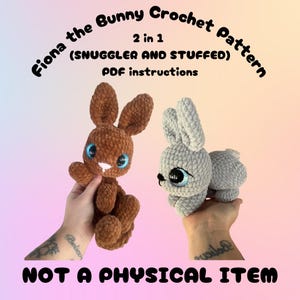 May include: Two crocheted bunny toys, one brown and one gray, with large blue eyes. The text reads "Fiona the Bunny Crochet Pattern" and "NOT A PHYSICAL ITEM". The pattern is for a snuggler and stuffed bunny.