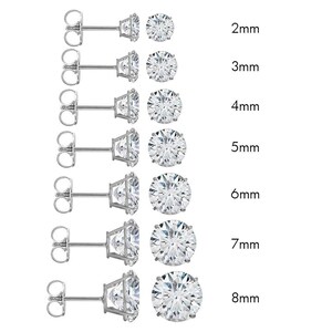May include: Set of 7 pairs of silver stud earrings with round clear cubic zirconia stones in sizes 2mm to 8mm.