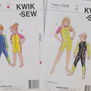 May include: Two Kwik Sew sewing pattern envelopes. Pattern 2432 features illustrations of children in colorful swimsuits. Pattern 2336 shows children in similar swimsuits. The envelopes are white with the Kwik Sew logo and pattern details.