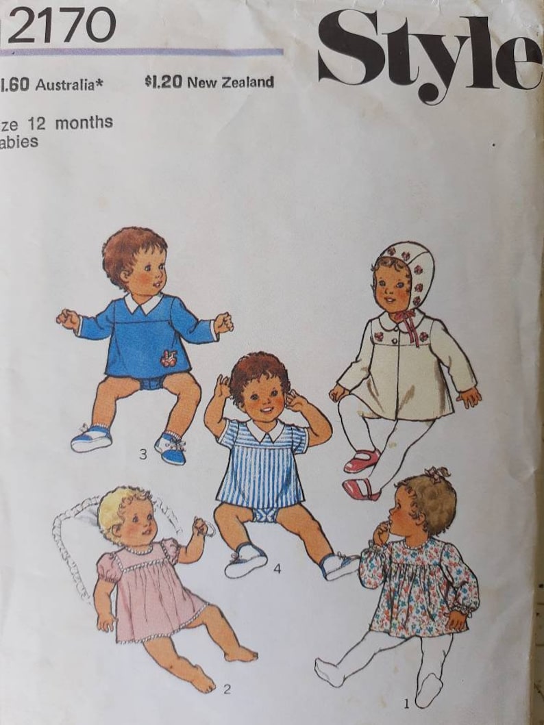 May include: Vintage sewing pattern featuring illustrations of baby clothing designs. The pattern includes drawings of a blue romper with a teddy bear, a pink dress, a striped romper, a floral top, and a white coat with a bonnet. The word "Style" is at the top.