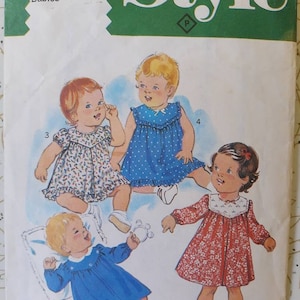 May include: Vintage sewing pattern featuring illustrations of four baby dresses. The dresses are in various styles, including a blue polka-dot dress, a red floral dress, and two dresses with floral patterns. The pattern is for size 18 months.