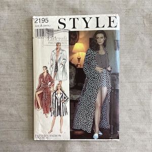 May include: A vintage sewing pattern labelled "STYLE 2195" with illustrations of a robe and other garments. The pattern cover shows a woman in a polka dot robe and a woman in a striped jacket. The size range is S-M-L-XL.