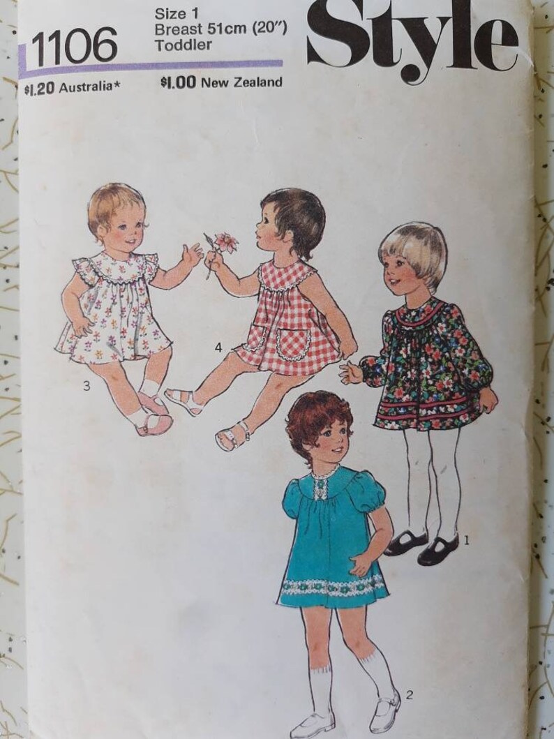 May include: Vintage sewing pattern for toddler dresses. The pattern features illustrations of four different dress styles. The text on the pattern reads "1106", "Size 1", and "Breast 20 inches".