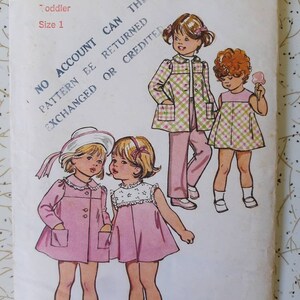 May include: A vintage Simplicity sewing pattern for toddler clothing, featuring illustrations of children's outfits. The pattern includes a pink coat, dress, and plaid jacket and pants set. The pattern number is 5436.
