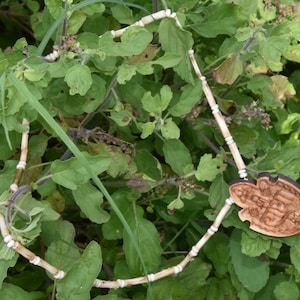 Tulsi mala With locket,There is a Tulsi garland which is a locket named shri Radha,it is made of  original tulsi which is worn around neck.