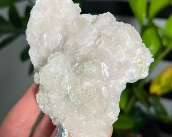 May include: A cluster of white and pink selenite crystals with a rough, textured surface.