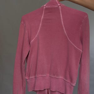 K&ouml;nnte beinhalten: Staubrosafarbene Jacke mit Rei&szlig;verschluss und hohem Kragen. Die R&uuml;ckseite der Jacke hat Rippendetails am oberen R&uuml;cken und an den unteren &Auml;rmeln. Die Jacke hat einen durchgehenden Rei&szlig;verschluss und gerippte B&uuml;ndchen und Saum.