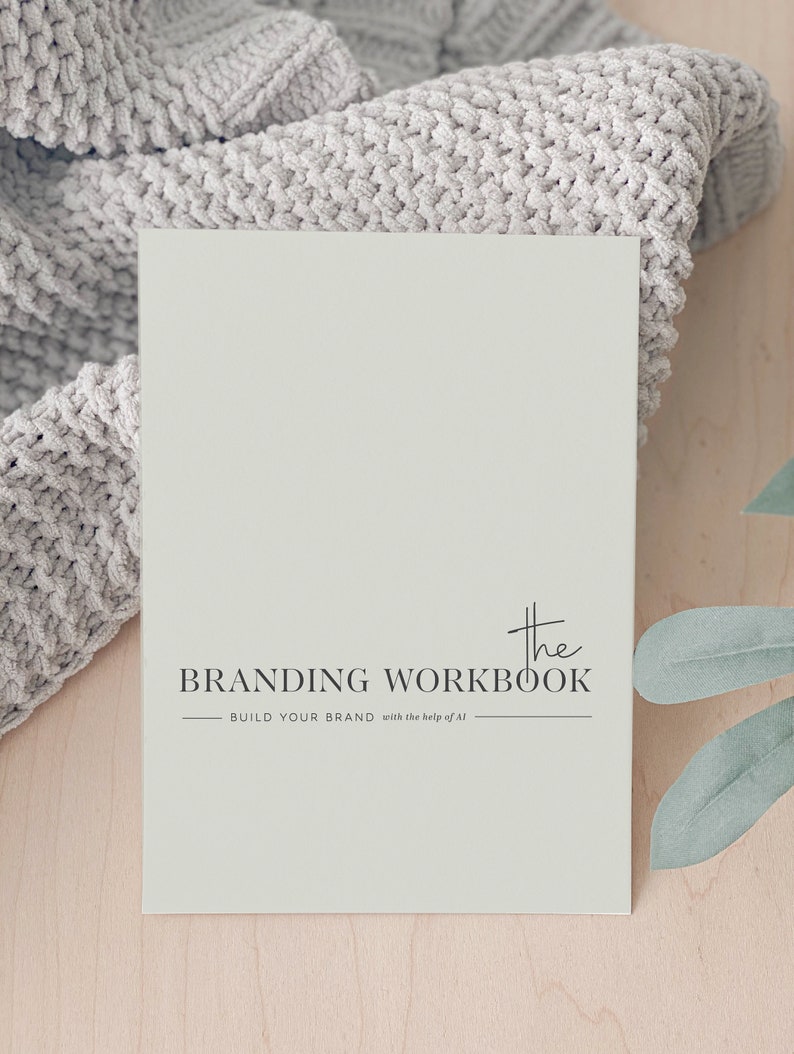 May include: A light green branding workbook with the text "The Branding Workbook - Build Your Brand with the help of AI" printed on the front.