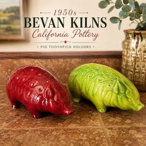 May include: Two ceramic pig toothpick holders, one in deep red and one in bright lime green, featuring embossed swirl patterns and multiple holes on the back. The text above reads 1950s BEVAN KILNS California Pottery PIG TOOTHPICK HOLDERS.