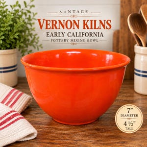 May include: A bright orange ceramic mixing bowl with a smooth, glossy finish. The bowl measures 7 inches in diameter and 4 1/2 inches tall. Text above the bowl reads VINTAGE VERNON KILNS EARLY CALIFORNIA POTTERY MIXING BOWL.