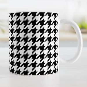 May include: A white ceramic mug with a black and white houndstooth pattern.