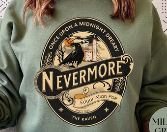 May include: A green sweatshirt with a round graphic featuring a raven, a pumpkin, and the text "Once Upon a Midnight Dreary, Nevermore, Edgar Allan Poe, Since 1845, The Raven".