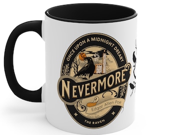 May include: A white coffee mug with a black rim and handle. The mug features a black and gold illustration of a raven, a pumpkin, and a candle with the text "Once upon a midnight dreary, Nevermore, Edgar Allen Poe, Since 1845, The Raven".
