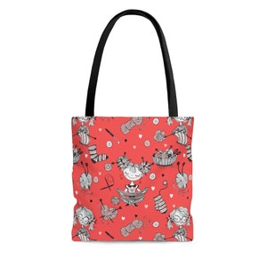May include: A red tote bag with a black handle featuring a repeating pattern of knitting-related illustrations. The pattern includes yarn balls, knitting needles, socks, and cartoon figures. The bag is designed for carrying items.