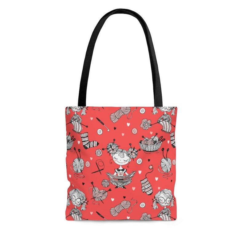 May include: A red tote bag with a black handle featuring a repeating pattern of knitting-related illustrations. The pattern includes yarn balls, knitting needles, socks, and cartoon figures. The bag is designed for carrying items.
