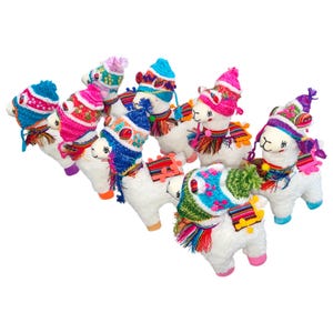 May include: A group of seven plush llama toys with colorful knitted hats and scarves. The llamas are white with black eyes and noses. The hats and scarves are in various colors, including pink, blue, purple, and green.
