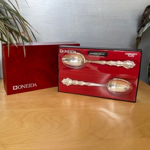 May include: Two silver spoons in a red box with the Oneida logo and the words "Mansion House Community Plate" on the box.