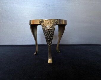 Vintage smaller sized brass trivet with grape decoration