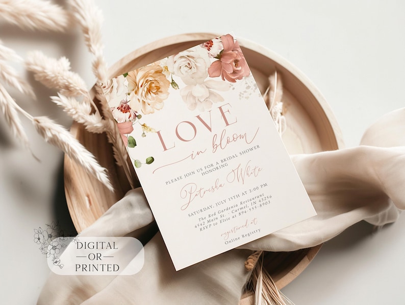 May include: A bridal shower invitation with floral accents and the words "Love in Bloom." The invitation features a soft color palette of blush, cream, and green, with the text "Digital - or - Printed."