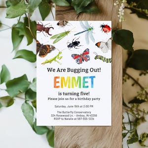 May include: A white invitation card with watercolor illustrations of various insects, including butterflies, a dragonfly, and a ladybug. The text reads "We Are Bugging Out! EMMET is turning five!"