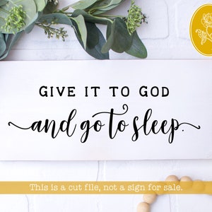 May include: White wooden sign with black text that reads "GIVE IT TO GOD and go to sleep".