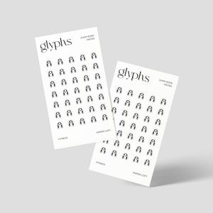 May include: Two white cards with the word "glyphs" at the top, featuring a repeating black jump rope icon. The cards also include the text "JUMP ROPE MICRO" and "PAPER LOFT" in a minimalist design.