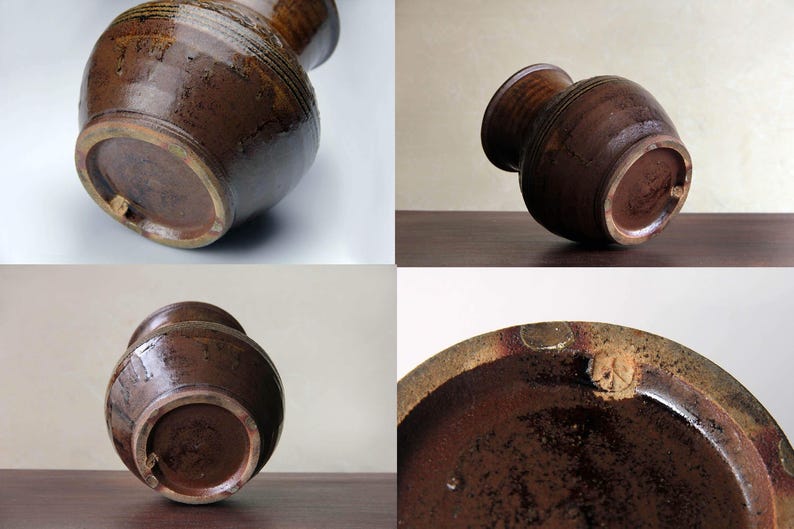 K&ouml;nnte beinhalten: Eine braune Keramikvase mit einer strukturierten Oberfl&auml;che und einer dunkelbraunen Glasur. Die Vase hat eine breite &Ouml;ffnung und einen schmalen Boden. Die Vase ist handgefertigt und hat einen einzigartigen, rustikalen Look.