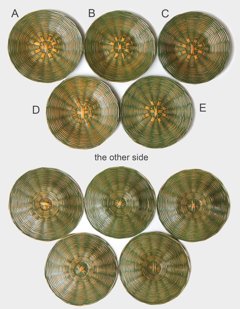 May include: A collection of woven, circular placemats in shades of green and gold. The placemats have a radial design with a central starburst pattern. The image shows both sides of the placemats, with the text "the other side" visible.