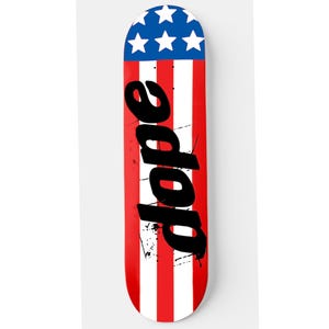 May include: A red, white, and blue skateboard deck with a graphic of the word "dope" in black lettering. The deck has a design that resembles the American flag.