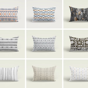 May include: Nine different throw pillow designs featuring geometric patterns in black, white, grey, brown, orange, and blue. The pillows are all rectangular and have a white background.