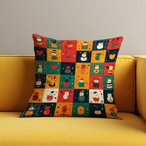 May include: Square decorative pillow with a patchwork design featuring colorful Christmas-themed illustrations. The pillow has a yellow, red, green, and blue color scheme with images of snowmen, reindeer, and hearts.