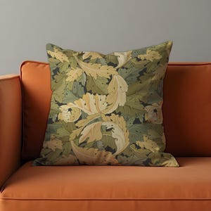 May include: A decorative cushion with a floral pattern featuring green and yellow leaves on a dark background.