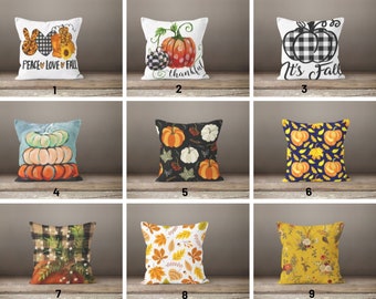 May include: Nine different throw pillow designs featuring fall themes. The pillows feature pumpkins, leaves, and plaid patterns in shades of orange, yellow, black, white, and blue. The pillows are arranged in three rows of three.