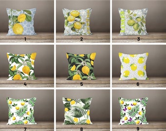 May include: Nine different pillow designs featuring lemons and lemon trees. The pillows are all square and have a white background. Some of the pillows have a black background. The pillows are all made of fabric and have a variety of patterns.