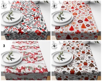 May include: Four different Christmas table runners with various designs. The first runner features a red, white, and gray pattern with holly, berries, and reindeer. The second runner has a white background with red, white, and gold stars, snowflakes, and Christmas trees. The third runner has a white background with red and white houses and trees. The fourth runner has a white background with red, white, and green trees, snowflakes, and the words "Happy New Year".
