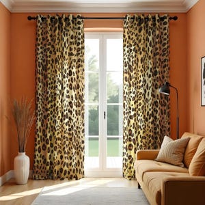 May include: A pair of brown and beige curtains with a leopard print pattern hang in front of a window. The curtains are made of a soft, textured fabric and have a subtle sheen. The curtains are hung on a black curtain rod with silver eyelets.