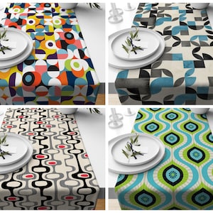 May include: Four different table runners with geometric patterns. The table runners are all 14 inches wide and 70 inches long. The patterns are all in different colours, including red, blue, green, yellow, black, and white.