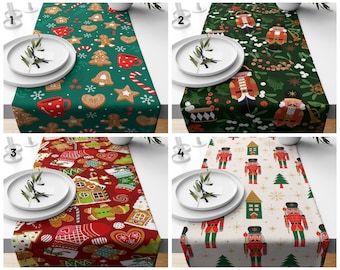 May include: Four different table runners with holiday themes. The first runner features gingerbread cookies and candy canes on a green background. The second runner features nutcrackers on a green background. The third runner features gingerbread houses and cookies on a red background. The fourth runner features nutcrackers and snowflakes on a cream background.