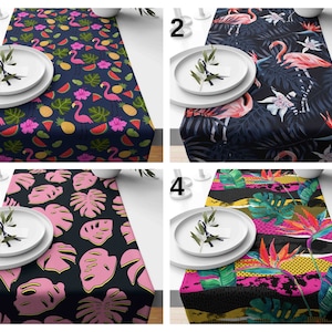 May include: Four different table runner designs with tropical themes. The first runner features pink flamingos, green leaves, and watermelon slices on a dark blue background. The second runner features pink flamingos, green leaves, and white flowers on a dark blue background. The third runner features pink monstera leaves on a dark blue background. The fourth runner features bright pink, yellow, and green tropical leaves and flowers on a black background.