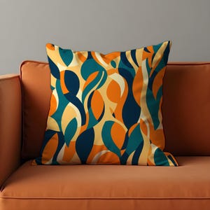 May include: A decorative throw pillow with an abstract pattern featuring teal, orange, and navy blue colors. The pillow is made of a soft, comfortable fabric and is perfect for adding a touch of style to any room.