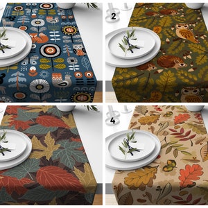 May include: Four different table runners with various patterns. The first runner features a blue background with colourful geometric shapes and animals. The second runner has a green background with owls, hedgehogs, and leaves. The third runner has a brown background with red and green leaves. The fourth runner has a beige background with brown and red leaves.