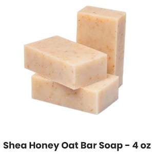 May include: Three bars of Shea Honey Oat Bar Soap, each bar is 4 oz. The bars are stacked on top of each other, with the top bar being the largest.